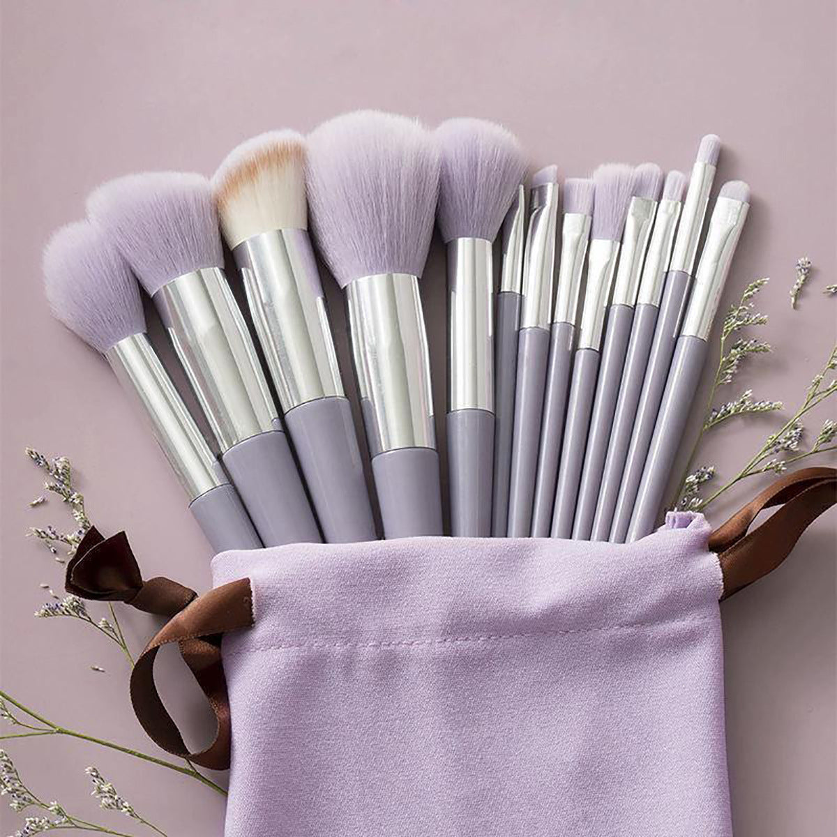 A set of thirteen makeup brushes